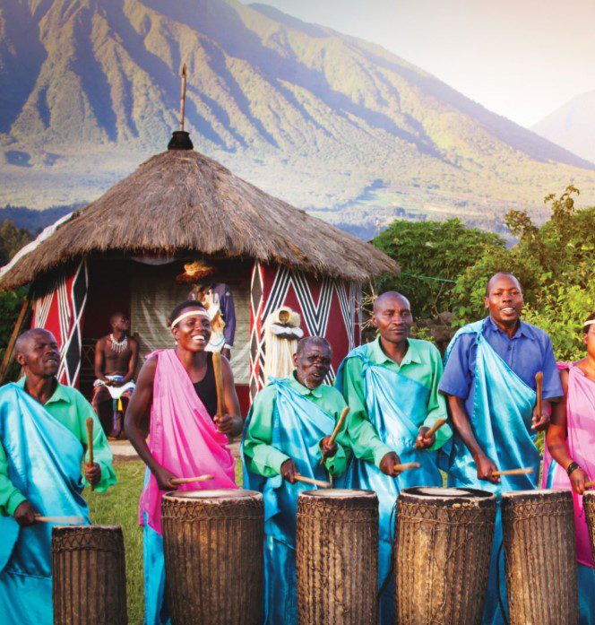 Rwandan locals engaging in traditional dance, demonstrating respect for elders, and wearing modest clothing in a vibrant cultural setting."