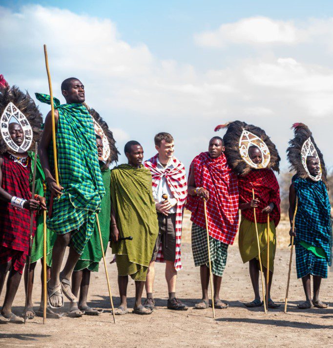 Traditional Tanzanian performers in Arusha dancing in colorful attire during a cultural celebration.