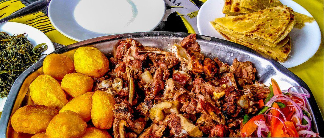 A delicious plate of Nyama Choma, showcasing perfectly roasted meat served with traditional Kenyan sides.