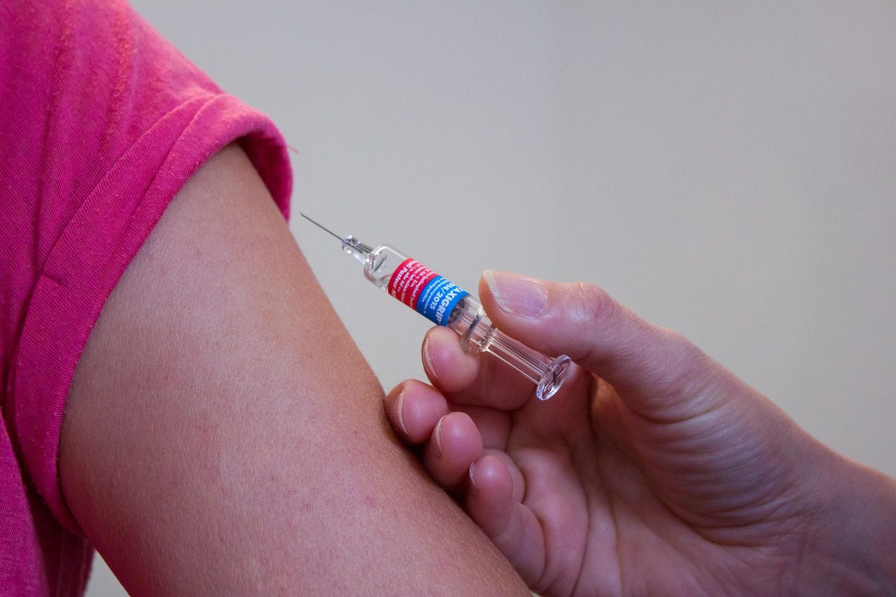 Woman receiving vaccination shot before traveling to Tanzania